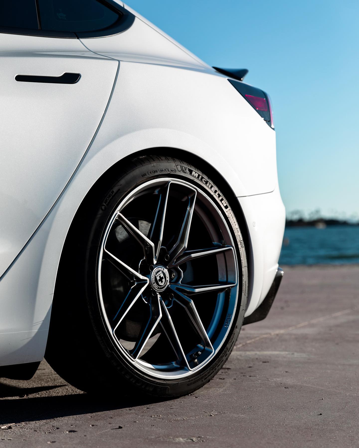 Tesla Model 3 in pearl white lowered on forged HRE Performance Wheels with Michelin tyres by Heinz Electrified